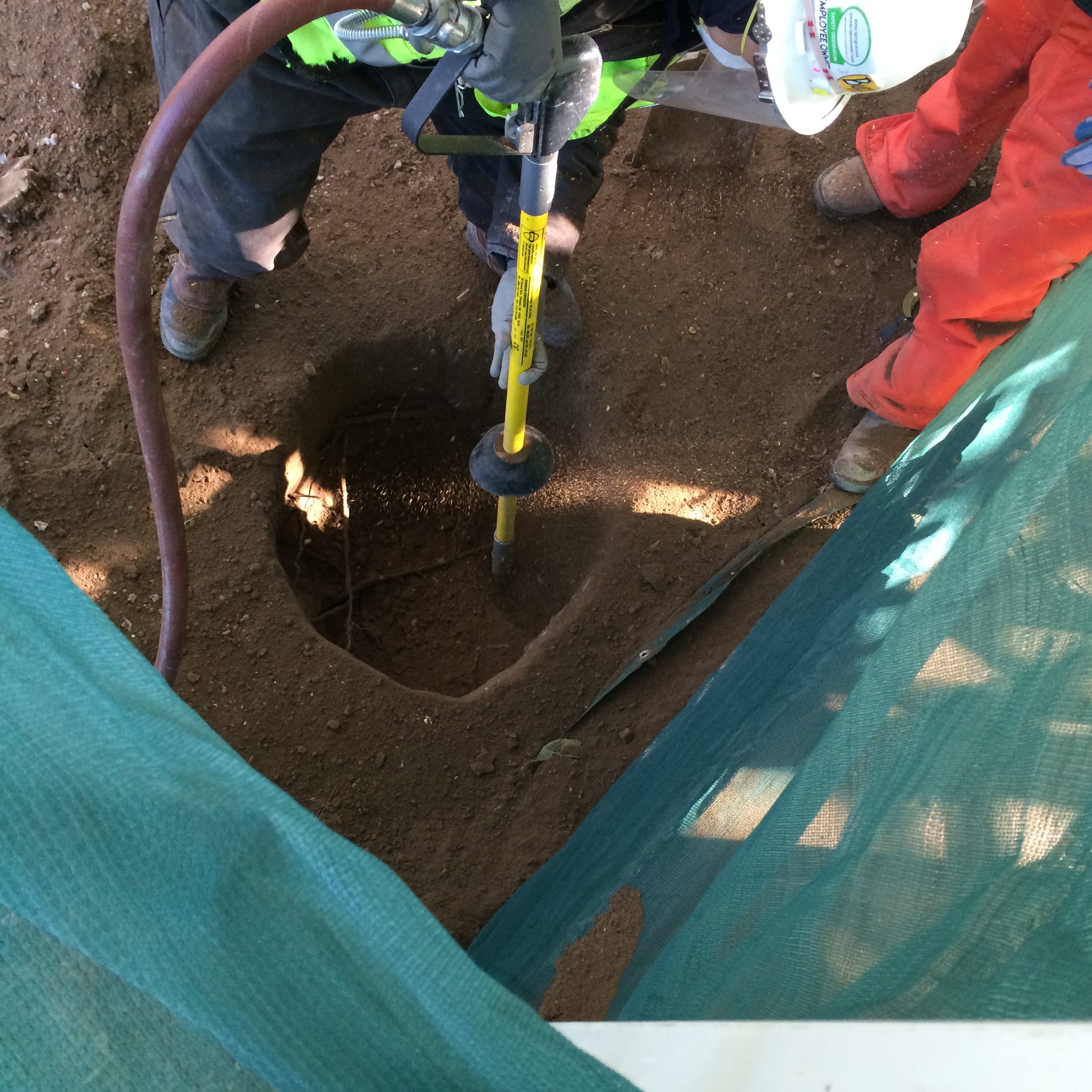 Air Spade Services 4 Air-Spade operator in safety gear excavating tree roots at Austin construction site