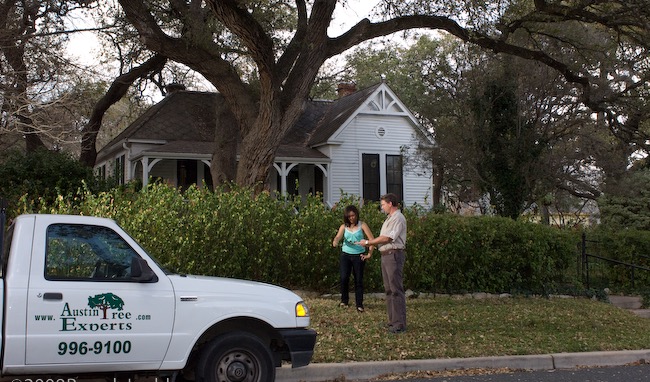 Austin Tree Experts arborist consulting with a customer at their home